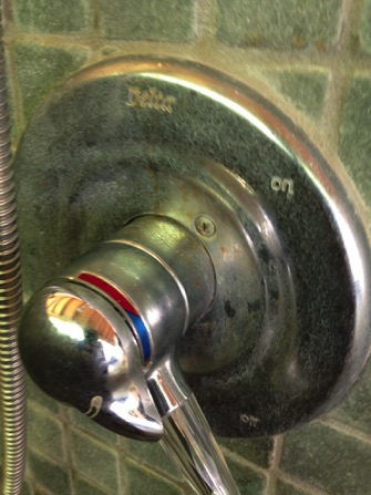 water stains on outdoor shower faucet before metal polishing